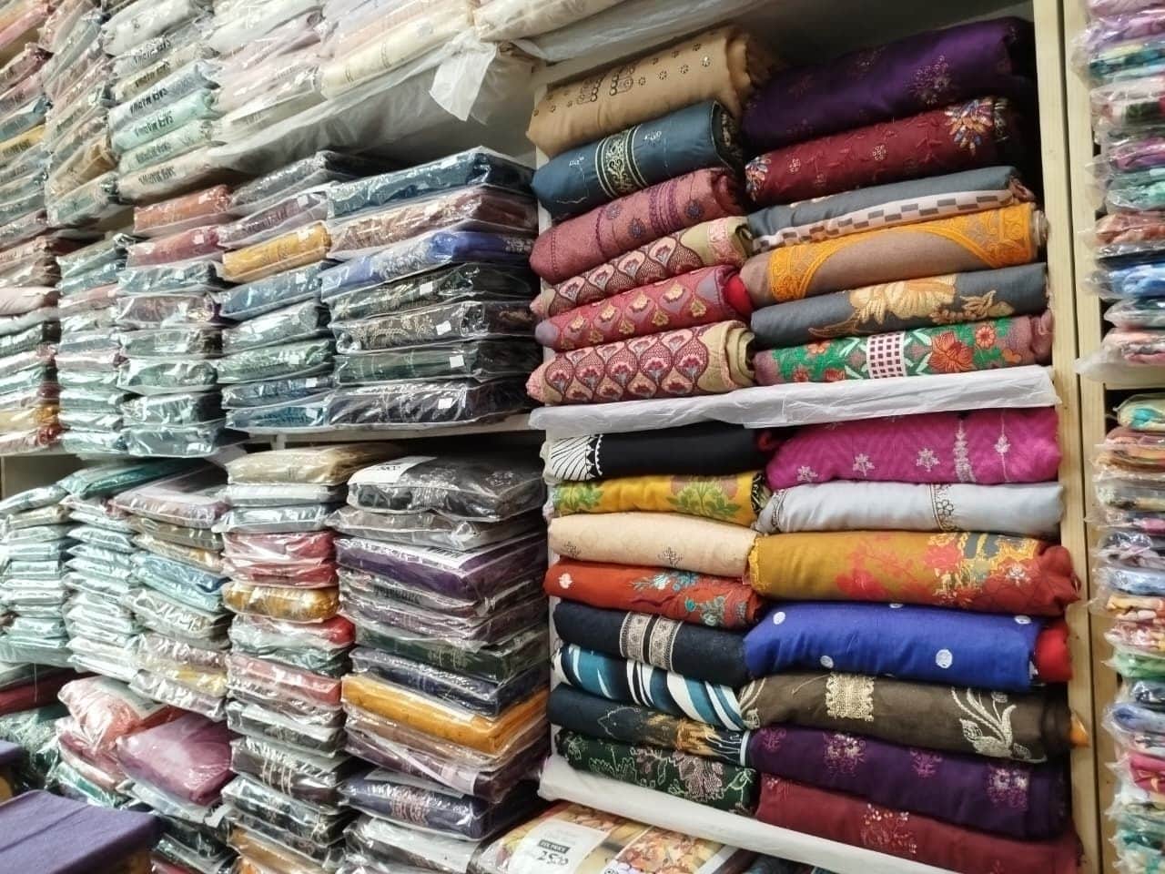 Shelves of embroidered and printed ladies suits at Shahzad Cloth House