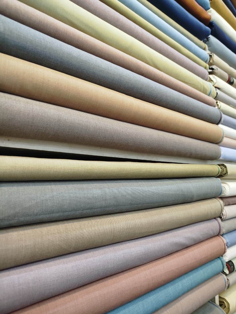 Folded wash & wear suiting in grey, sand, peach and blue at Shahzad Cloth House