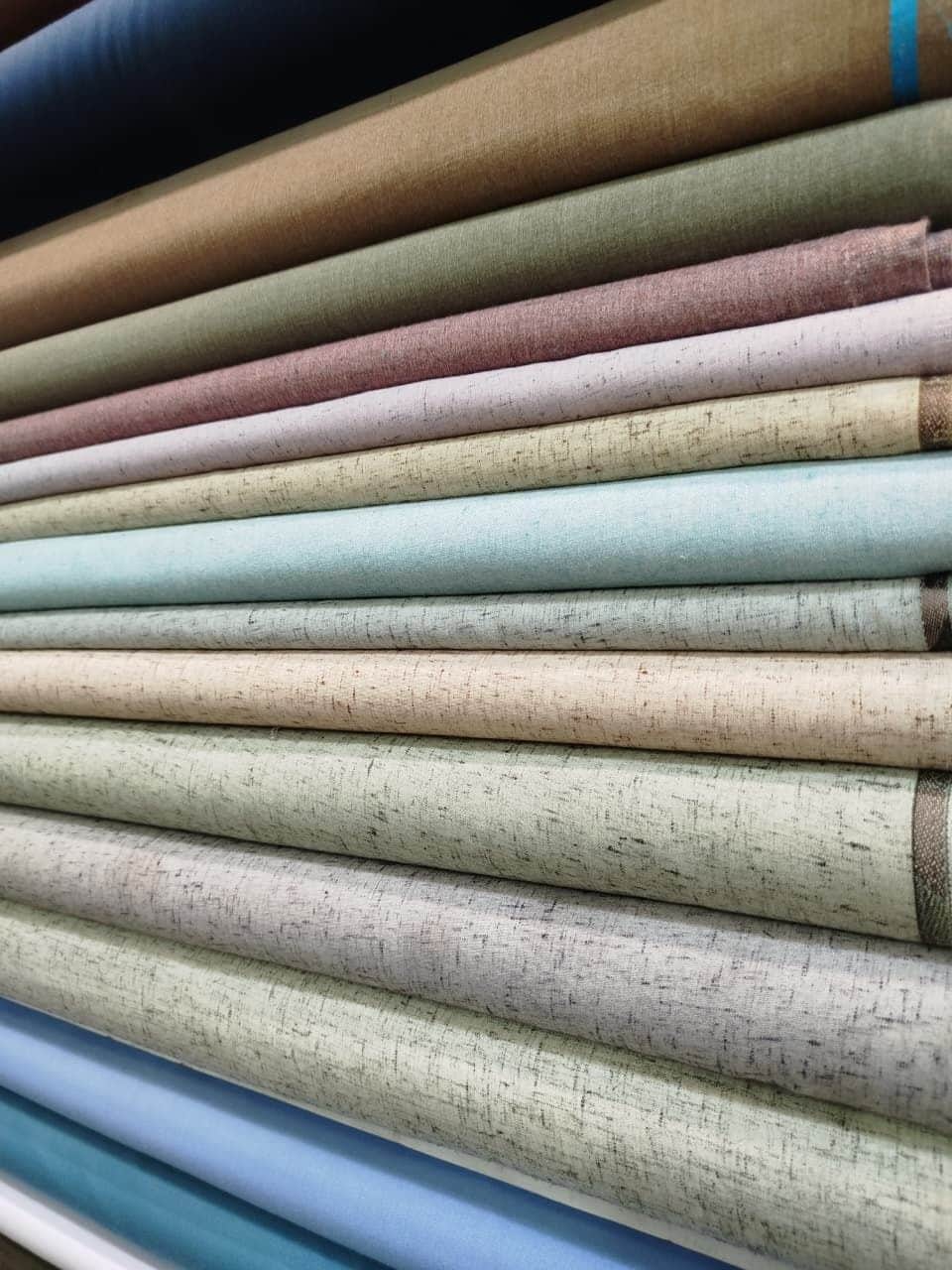 Rolls of light cotton and wash & wear in pastel shades at Shahzad Cloth House