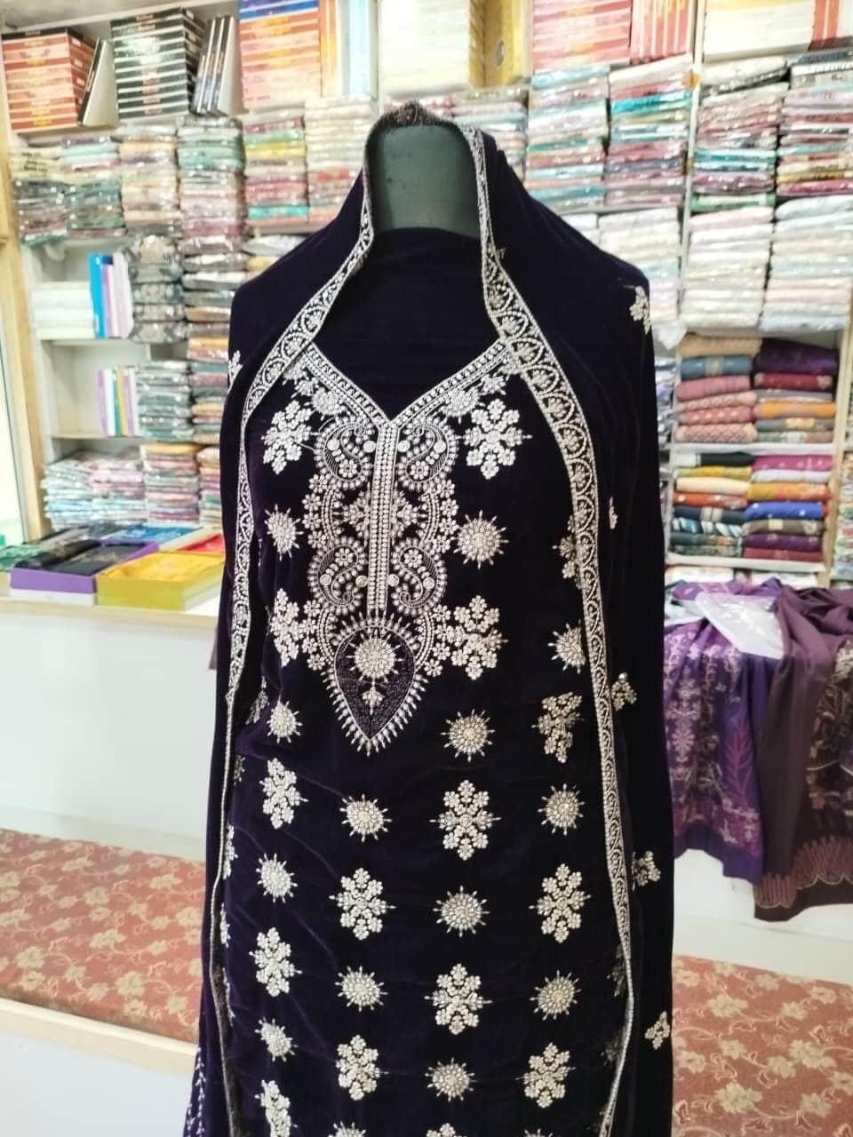 Close view of an embroidered velvet suit on a mannequin at Shahzad Cloth House