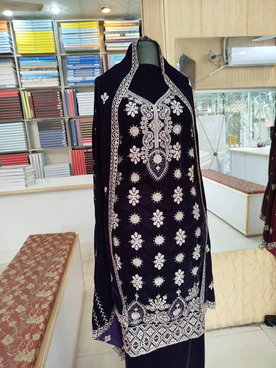 Embroidered velvet suit on display in the shop at Shahzad Cloth House